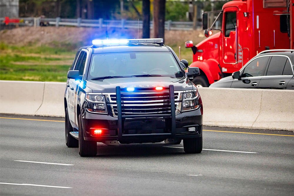 police vehicle on sie of interstate